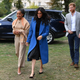 Meghan, Duchess of Sussex (C) arrives with her mother Doria Ragland (L) and Prince Harry, Duke of Sussex to host an event to mark the launch of a cookbook with recipes from a group of women affected by the Grenfell Tower fire on Sept. 20, 2018 in London, England.